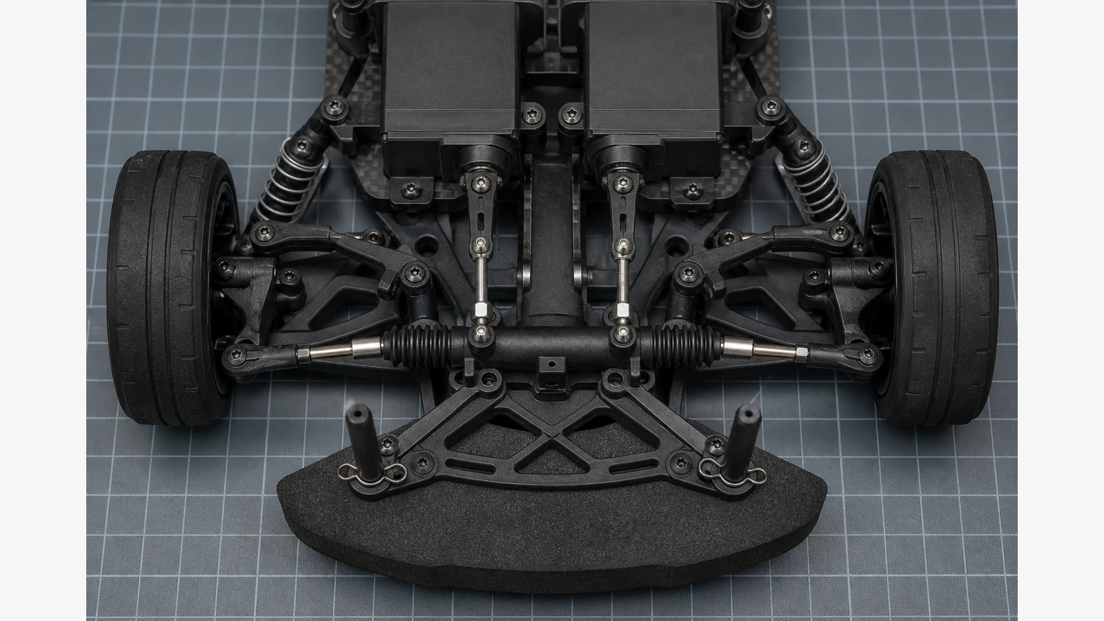 Two RC steering servos aligned with parallel linkages and straight wheels